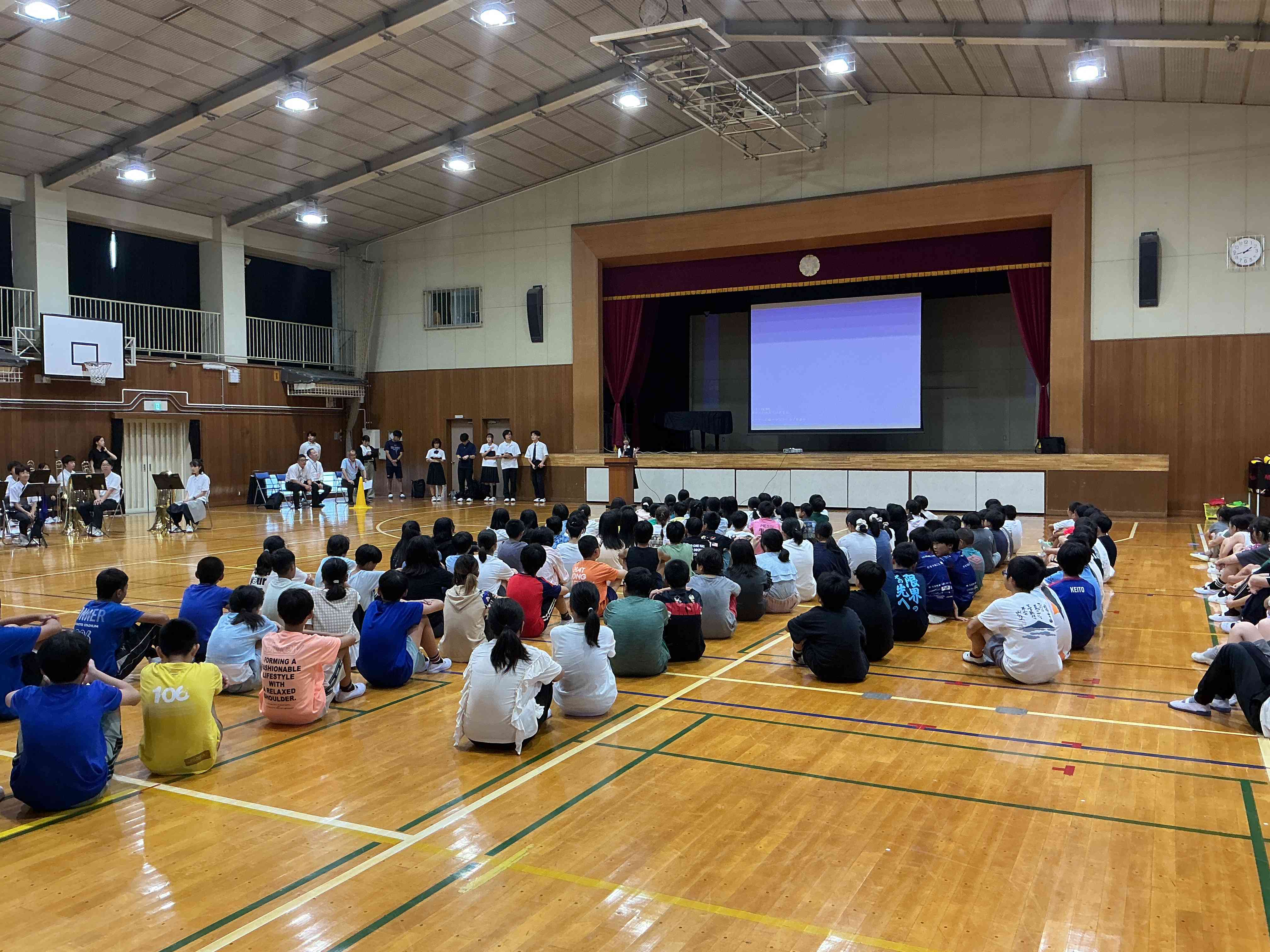 中学校体育館で生徒会の話を聞く様子